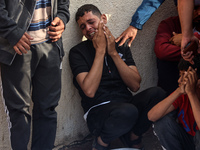 Palestinians are mourning relatives killed in Israeli bombardment of a house in al-Maghazi refugee camp, at the Al-Aqsa Martyrs Hospital in...