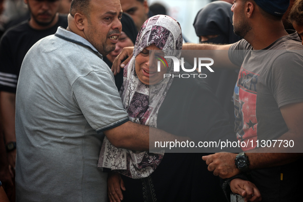 Palestinians are mourning relatives killed in Israeli bombardment of a house in al-Maghazi refugee camp, at the Al-Aqsa Martyrs Hospital in...