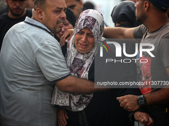 Palestinians are mourning relatives killed in Israeli bombardment of a house in al-Maghazi refugee camp, at the Al-Aqsa Martyrs Hospital in...