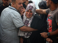 Palestinians are mourning relatives killed in Israeli bombardment of a house in al-Maghazi refugee camp, at the Al-Aqsa Martyrs Hospital in...