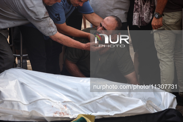 Palestinians are mourning relatives killed in Israeli bombardment of a house in al-Maghazi refugee camp, at the Al-Aqsa Martyrs Hospital in...