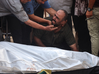 Palestinians are mourning relatives killed in Israeli bombardment of a house in al-Maghazi refugee camp, at the Al-Aqsa Martyrs Hospital in...