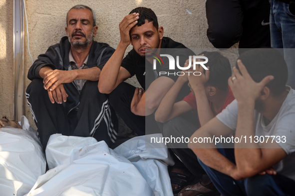 Palestinians are mourning relatives killed in Israeli bombardment of a house in al-Maghazi refugee camp, at the Al-Aqsa Martyrs Hospital in...