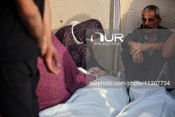 Palestinians are mourning relatives killed in Israeli bombardment of a house in al-Maghazi refugee camp, at the Al-Aqsa Martyrs Hospital in...