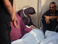 Palestinians are mourning relatives killed in Israeli bombardment of a house in al-Maghazi refugee camp, at the Al-Aqsa Martyrs Hospital in...