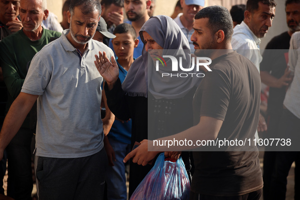 Palestinians are mourning relatives killed in Israeli bombardment of a house in al-Maghazi refugee camp, at the Al-Aqsa Martyrs Hospital in...