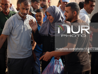 Palestinians are mourning relatives killed in Israeli bombardment of a house in al-Maghazi refugee camp, at the Al-Aqsa Martyrs Hospital in...