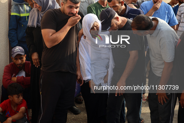 Palestinians are mourning relatives killed in Israeli bombardment of a house in al-Maghazi refugee camp, at the Al-Aqsa Martyrs Hospital in...