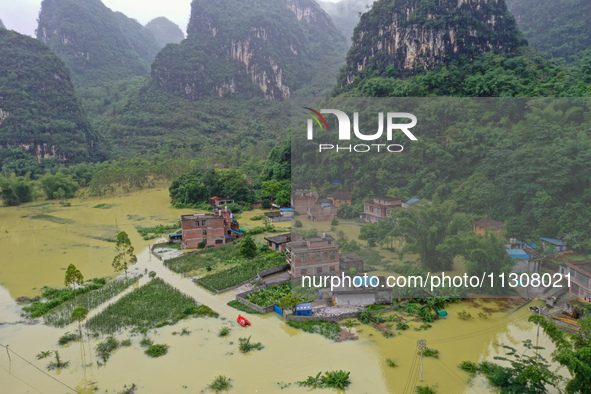 Flood waters are surrounding Shilong Village, Gongchuan Township, Dahua County, Hechi City, Guangxi Province, China, on June 5, 2024. 