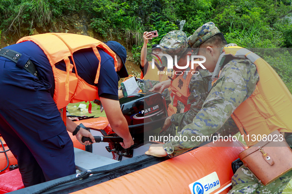 Armed police officers are testing rubber boats at Shilong Village, Gongchuan Township, Dahua county, in Hechi, China, on June 5, 2024. 