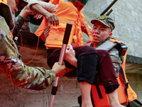 Armed police officers are moving victims of a disaster in Shilong Village, Gongchuan Township, Dahua County, Hechi city, South China's Guang...