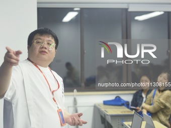 A teacher is teaching students how to make short videos in a classroom in Hangzhou, China, on June 5, 2024. (