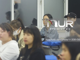 A teacher is teaching students how to make short videos in a classroom in Hangzhou, China, on June 5, 2024. (