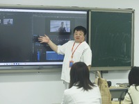 A teacher is teaching students how to make short videos in a classroom in Hangzhou, China, on June 5, 2024. (