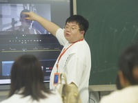 A teacher is teaching students how to make short videos in a classroom in Hangzhou, China, on June 5, 2024. (