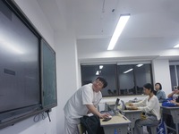 A teacher is teaching students how to make short videos in a classroom in Hangzhou, China, on June 5, 2024. (