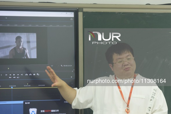 A teacher is teaching students how to make short videos in a classroom in Hangzhou, China, on June 5, 2024. 