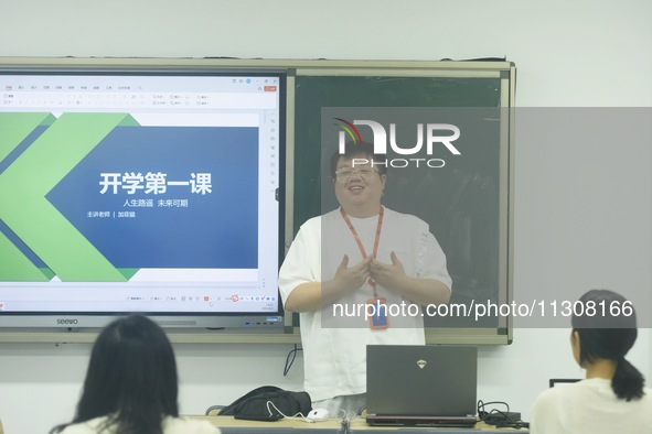 A teacher is teaching students how to make short videos in a classroom in Hangzhou, China, on June 5, 2024. 