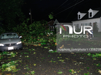 Residents of a Gaithersburg, Maryland neighborhood gather to survey damage on June 5, 2024, after a tornado swept through the region. (