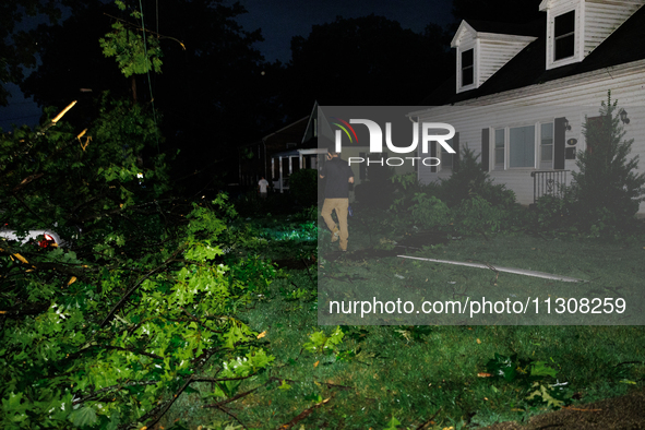 Residents of a Gaithersburg, Maryland neighborhood gather to survey damage on June 5, 2024, after a tornado swept through the region. 