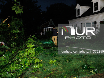 Residents of a Gaithersburg, Maryland neighborhood gather to survey damage on June 5, 2024, after a tornado swept through the region. (