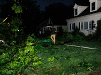 Residents of a Gaithersburg, Maryland neighborhood gather to survey damage on June 5, 2024, after a tornado swept through the region. (