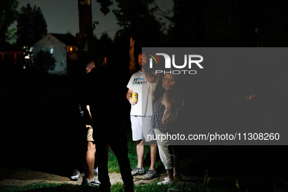 Residents of a Gaithersburg, Maryland neighborhood gather to survey damage on June 5, 2024, after a tornado swept through the region. 