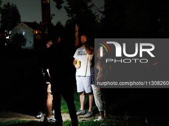 Residents of a Gaithersburg, Maryland neighborhood gather to survey damage on June 5, 2024, after a tornado swept through the region. (