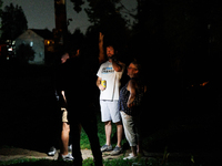 Residents of a Gaithersburg, Maryland neighborhood gather to survey damage on June 5, 2024, after a tornado swept through the region. (