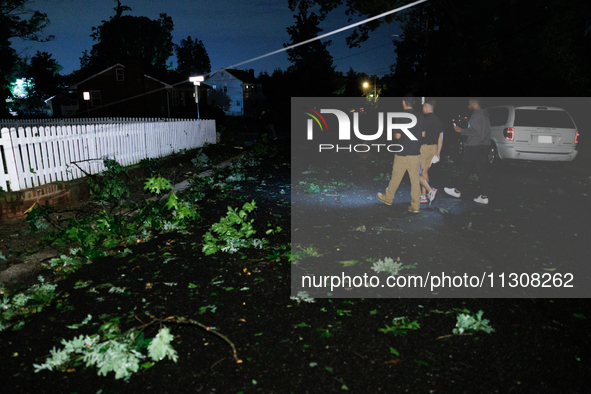 Residents of a Gaithersburg, Maryland neighborhood gather to survey damage on June 5, 2024, after a tornado swept through the region. 