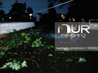 Residents of a Gaithersburg, Maryland neighborhood gather to survey damage on June 5, 2024, after a tornado swept through the region. (