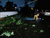 Residents of a Gaithersburg, Maryland neighborhood gather to survey damage on June 5, 2024, after a tornado swept through the region. (