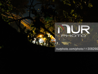 A utility repair vehicle's light is seen beyond a fallen tree in a Gaithersburg, Maryland neighborhood on June 5, 2024, after a tornado swep...