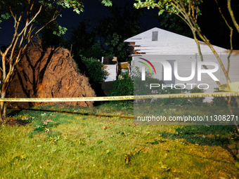 A fallen tree rests inside a home on Dogwood Drive in Gaithersburg, Maryland on June 5, 2024, after a tornado swept through the region. (