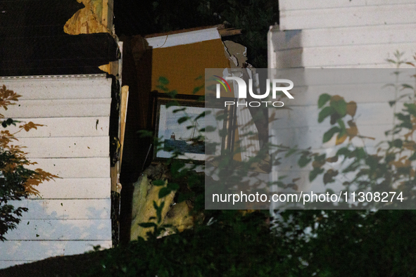 A painting is seen inside a home on Dogwood Drive in Gaithersburg, Maryland that was split in half by a fallen tree on June 5, 2024, after a...