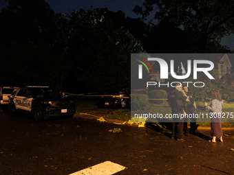 A resident talks with police after a tornado swept through a Gaithersburg, Maryland neighborhood on June 5, 2024. (