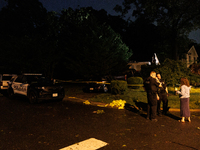 A resident talks with police after a tornado swept through a Gaithersburg, Maryland neighborhood on June 5, 2024. (