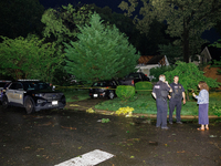 A resident talks with police after a tornado swept through a Gaithersburg, Maryland neighborhood on June 5, 2024. (