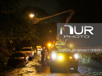 Utility crews make repairs in a Gaithersburg, Maryland neighborhood on June 5, 2024, after a tornado swept through the region. (