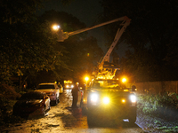 Utility crews make repairs in a Gaithersburg, Maryland neighborhood on June 5, 2024, after a tornado swept through the region. (