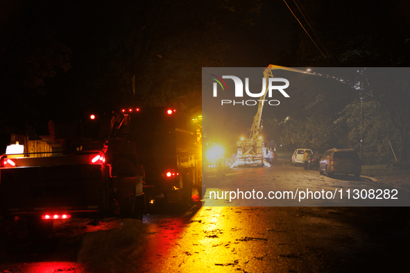 Utility crews make repairs in a Gaithersburg, Maryland neighborhood on June 5, 2024, after a tornado swept through the region. 