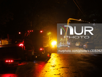 Utility crews make repairs in a Gaithersburg, Maryland neighborhood on June 5, 2024, after a tornado swept through the region. (