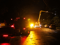 Utility crews make repairs in a Gaithersburg, Maryland neighborhood on June 5, 2024, after a tornado swept through the region. (