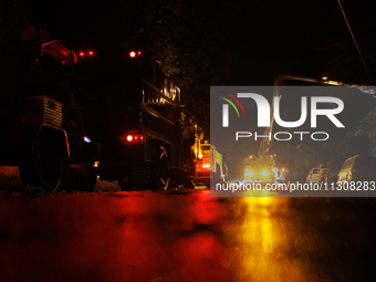 Utility crews make repairs in a Gaithersburg, Maryland neighborhood on June 5, 2024, after a tornado swept through the region. (