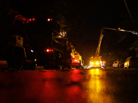 Utility crews make repairs in a Gaithersburg, Maryland neighborhood on June 5, 2024, after a tornado swept through the region. (