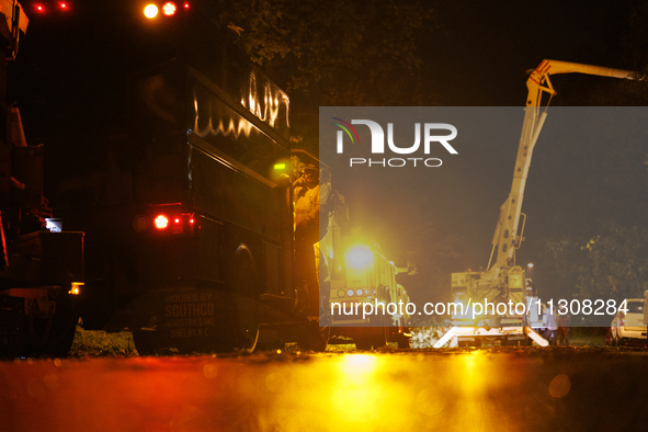 Utility crews make repairs in a Gaithersburg, Maryland neighborhood on June 5, 2024, after a tornado swept through the region. 