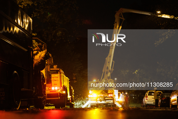 Utility crews make repairs in a Gaithersburg, Maryland neighborhood on June 5, 2024, after a tornado swept through the region. 