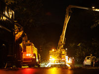 Utility crews make repairs in a Gaithersburg, Maryland neighborhood on June 5, 2024, after a tornado swept through the region. (