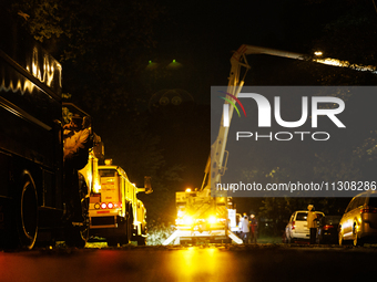 Utility crews make repairs in a Gaithersburg, Maryland neighborhood on June 5, 2024, after a tornado swept through the region. (