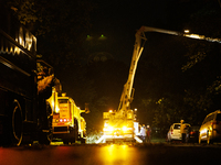 Utility crews make repairs in a Gaithersburg, Maryland neighborhood on June 5, 2024, after a tornado swept through the region. (